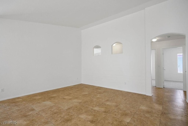 7755 Pacific Rim Ct, Las Vegas, NV 89139 - spare room featuring arched walkways and baseboards