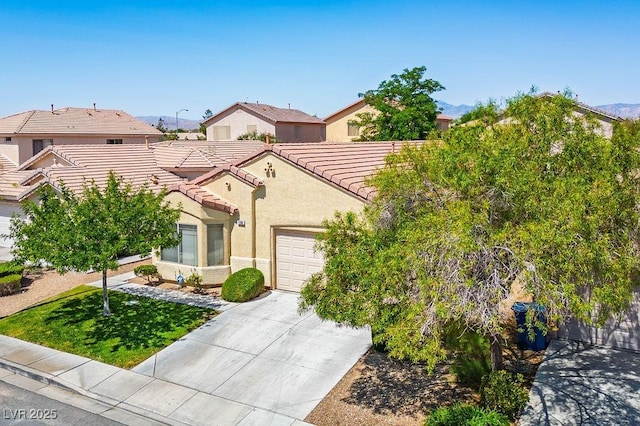 7755 Pacific Rim Ct, Las Vegas, NV 89139 - mediterranean / spanish house with a garage, a tiled roof, stucco siding, and concrete driveway