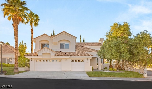 8100 Lake Hills Dr, Las Vegas, NV 89128 - mediterranean / spanish-style house with concrete driveway, stucco siding, a tile roof, a garage, and a front yard