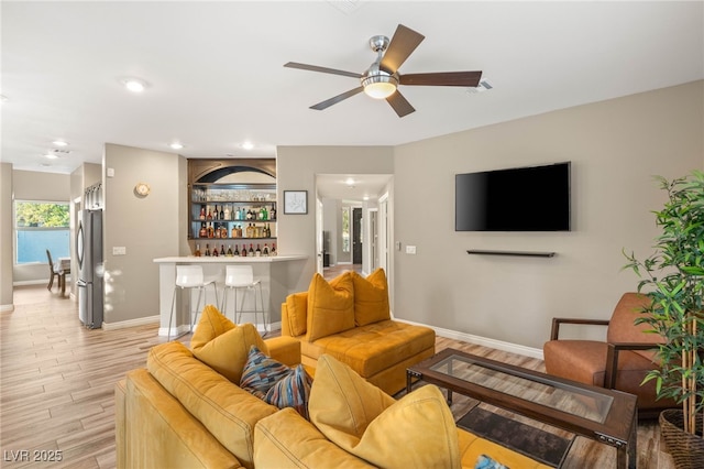 8100 Lake Hills Dr, Las Vegas, NV 89128 - living room featuring baseboards, light wood-style flooring, a ceiling fan, bar area, and recessed lighting