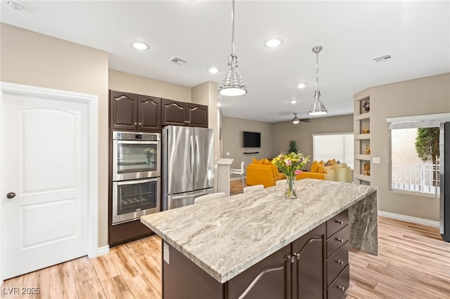 8100 Lake Hills Dr, Las Vegas, NV 89128 - kitchen with appliances with stainless steel finishes, dark brown cabinets, baseboards, light wood-style flooring, and recessed lighting