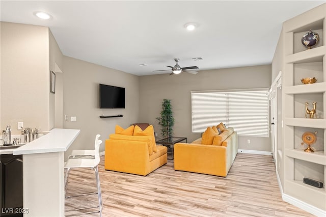 8100 Lake Hills Dr, Las Vegas, NV 89128 - living room with ceiling fan, baseboards, light wood-style flooring, built in shelves, and recessed lighting