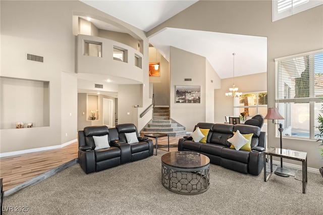 8100 Lake Hills Dr, Las Vegas, NV 89128 - carpeted living area featuring high vaulted ceiling, baseboards, a chandelier, and stairway