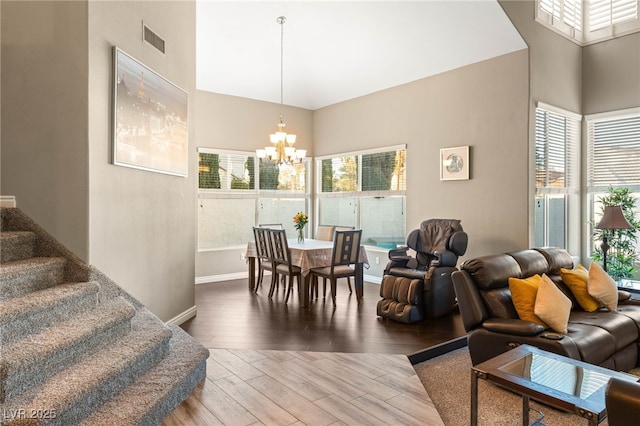 8100 Lake Hills Dr, Las Vegas, NV 89128 - living room featuring high vaulted ceiling, a chandelier, wood finished floors, stairs, and baseboards