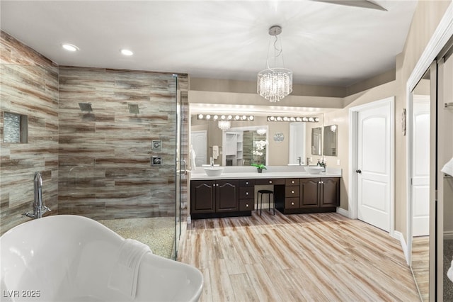 8100 Lake Hills Dr, Las Vegas, NV 89128 - full bath with double vanity, a soaking tub, a stall shower, a chandelier, and recessed lighting