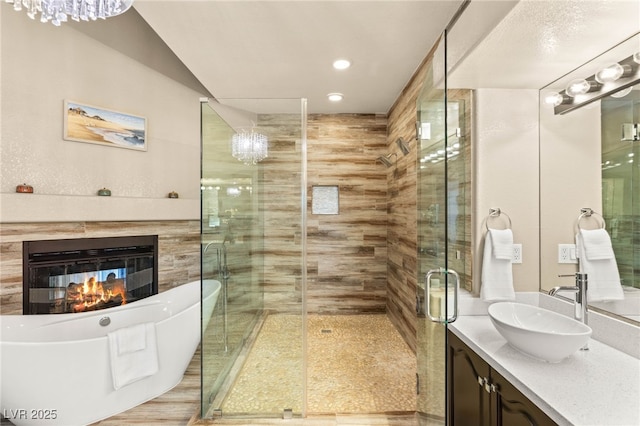8100 Lake Hills Dr, Las Vegas, NV 89128 - bathroom featuring vanity, a soaking tub, a stall shower, a multi sided fireplace, and recessed lighting
