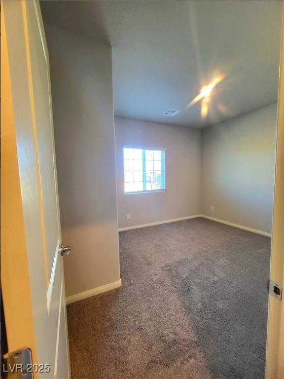 empty room with carpet flooring and baseboards