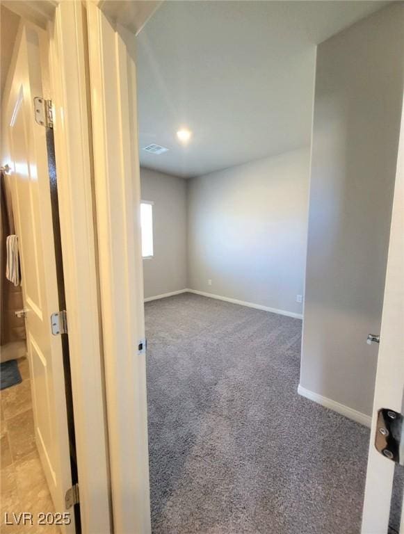 empty room with carpet flooring and baseboards