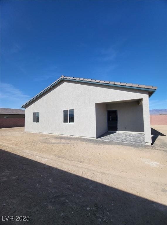 back of house featuring stucco siding