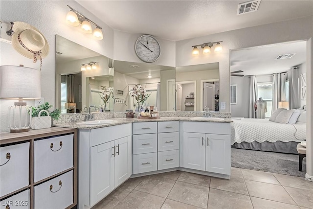 bathroom with tile patterned floors, double vanity, and connected bathroom