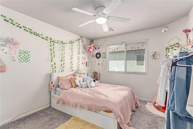 carpeted bedroom with baseboards and a ceiling fan