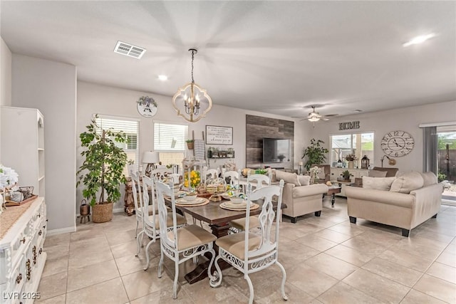 dining area featuring light tile patterned floors, a chandelier, and ceiling fan