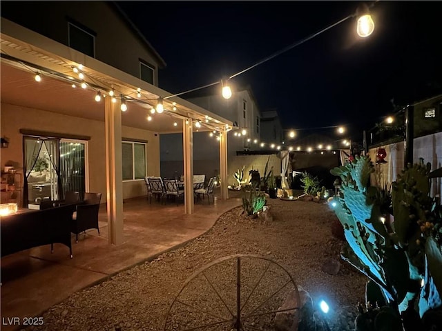 yard at twilight with a patio and outdoor dining space