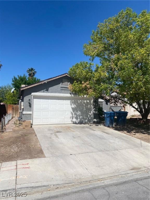 1841 Skywood Way, Las Vegas, NV 89142 - view of front of house featuring concrete driveway, fence, and a garage