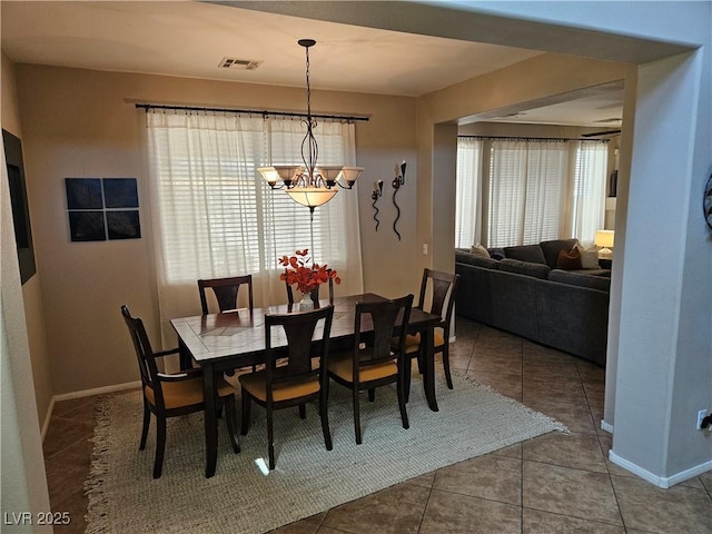 dining area with plenty of natural light, a chandelier, and tile patterned floors