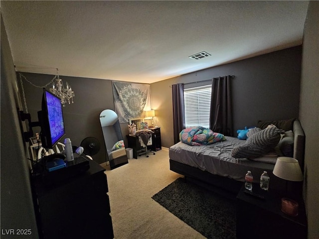 bedroom featuring carpet flooring and a chandelier