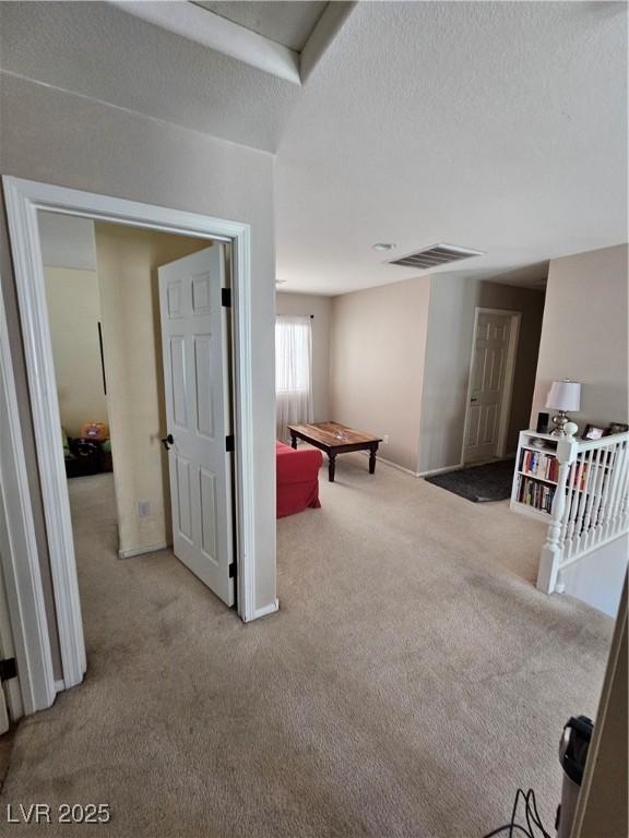 recreation room with carpet and baseboards