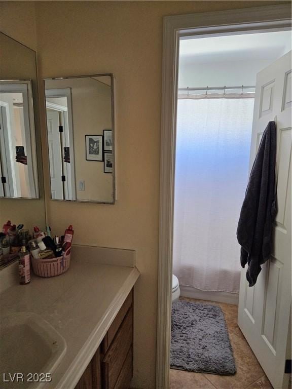 bathroom with vanity, toilet, and tile patterned flooring