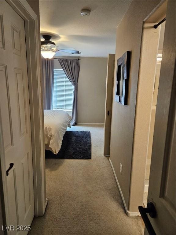 bedroom featuring light carpet and baseboards