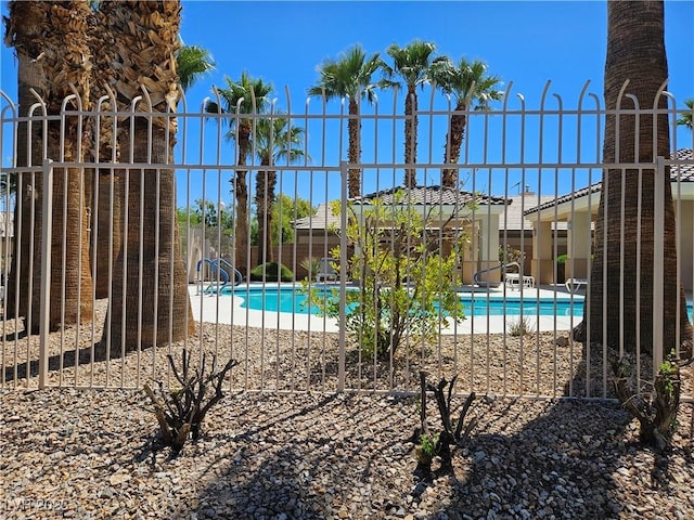 community pool featuring a patio area and fence