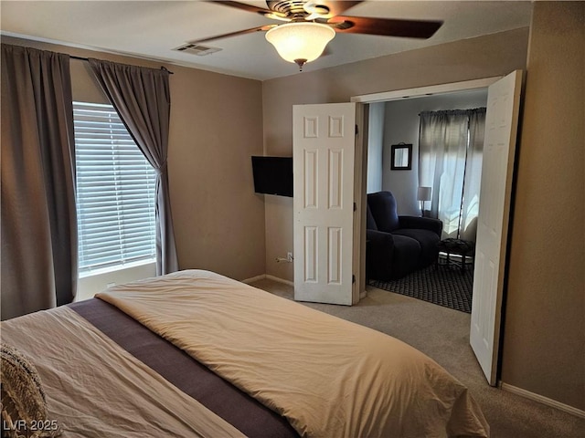 carpeted bedroom featuring a ceiling fan and baseboards