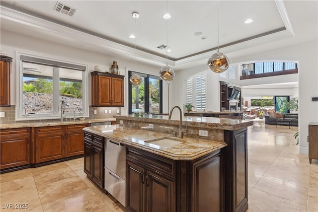 kitchen featuring a sink, dishwasher, backsplash, healthy amount of natural light, and recessed lighting
