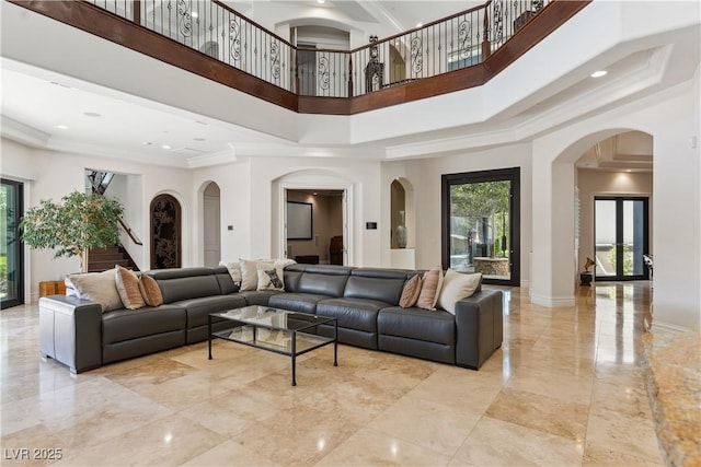 common area featuring a high ceiling, ornamental molding, and stairs