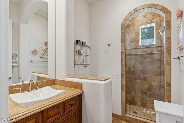 bathroom with a stall shower and vanity