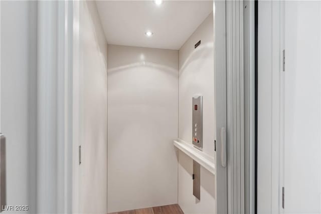 bathroom featuring elevator and recessed lighting