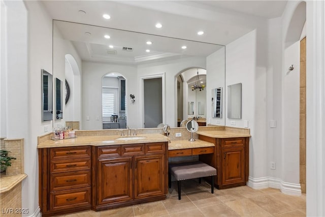 full bathroom featuring a raised ceiling, vanity, a chandelier, recessed lighting, and tile patterned flooring
