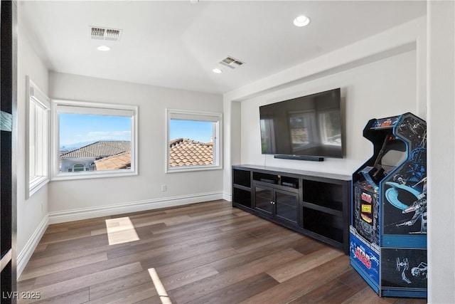 bar featuring wood finished floors, baseboards, and recessed lighting