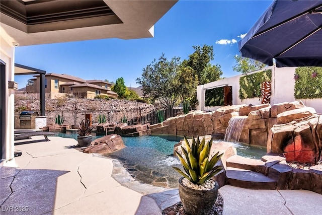 view of swimming pool featuring fence and a patio