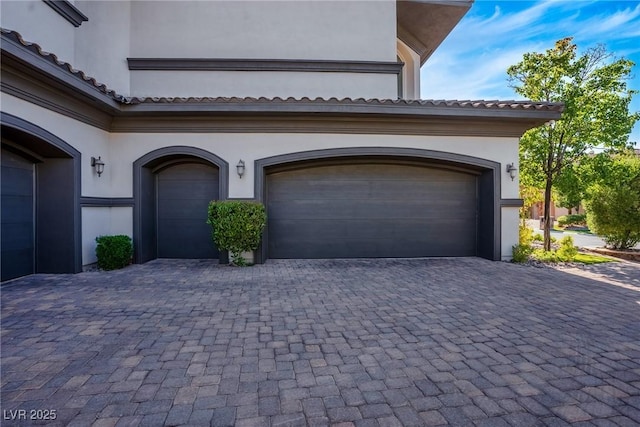 garage featuring decorative driveway