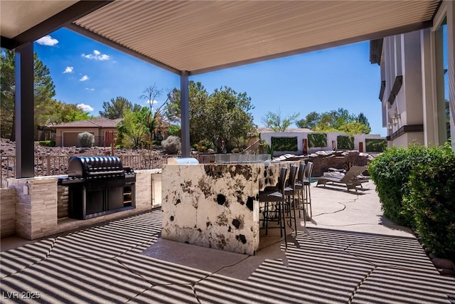 view of patio featuring an outdoor kitchen and grilling area