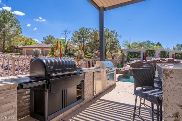 view of patio featuring exterior kitchen and grilling area