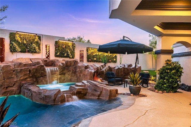 view of patio featuring an in-ground hot tub