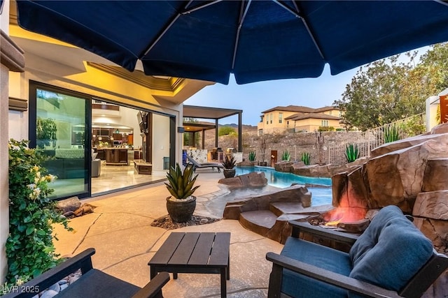 view of patio / terrace with an outdoor fire pit and fence