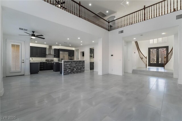 1316 Eagle Meadow Ct, Las Vegas, NV 89123 - unfurnished living room featuring a high ceiling, ceiling fan, stairway, baseboards, and a sink