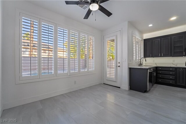 1316 Eagle Meadow Ct, Las Vegas, NV 89123 - kitchen featuring ceiling fan, light countertops, baseboards, dark cabinets, and dishwashing machine