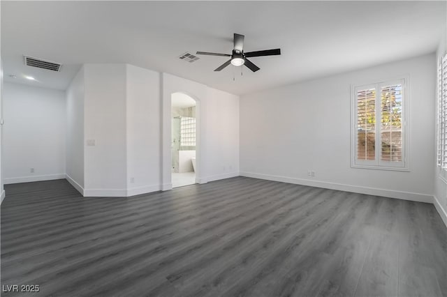 1316 Eagle Meadow Ct, Las Vegas, NV 89123 - spare room with arched walkways, a ceiling fan, dark wood-style floors, and baseboards