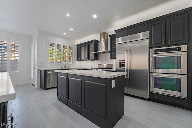 1316 Eagle Meadow Ct, Las Vegas, NV 89123 - kitchen with stainless steel appliances, wall chimney range hood, dark cabinets, light countertops, and a kitchen island