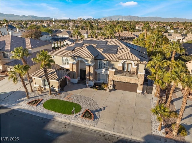 1316 Eagle Meadow Ct, Las Vegas, NV 89123 - view of front of property with a residential view, concrete driveway, an attached garage, roof mounted solar panels, and a mountain view