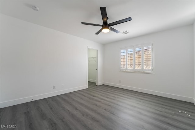 1316 Eagle Meadow Ct, Las Vegas, NV 89123 - unfurnished bedroom with baseboards, dark wood-type flooring, a spacious closet, and a ceiling fan