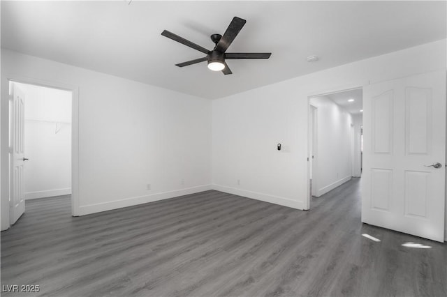 1316 Eagle Meadow Ct, Las Vegas, NV 89123 - unfurnished bedroom with wood finished floors, baseboards, a walk in closet, a closet, and ceiling fan