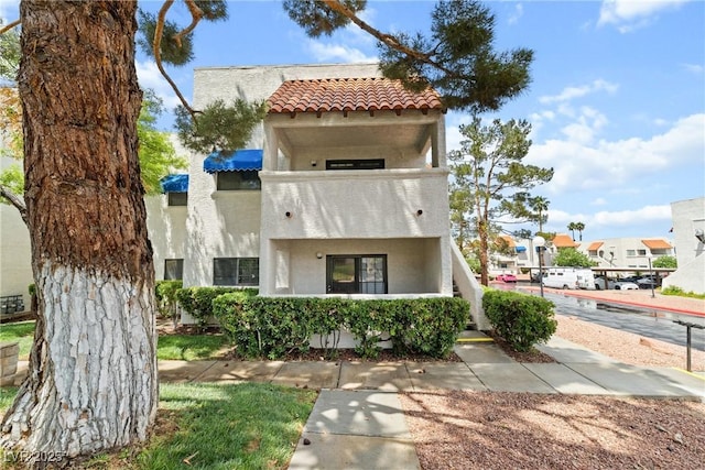 mediterranean / spanish home with stucco siding and a tile roof