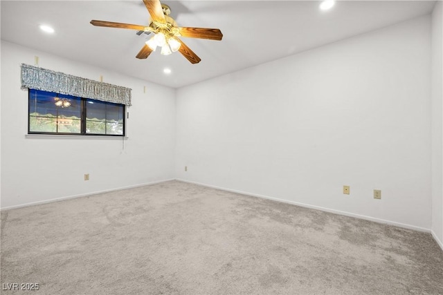 carpeted empty room with recessed lighting, a ceiling fan, and baseboards