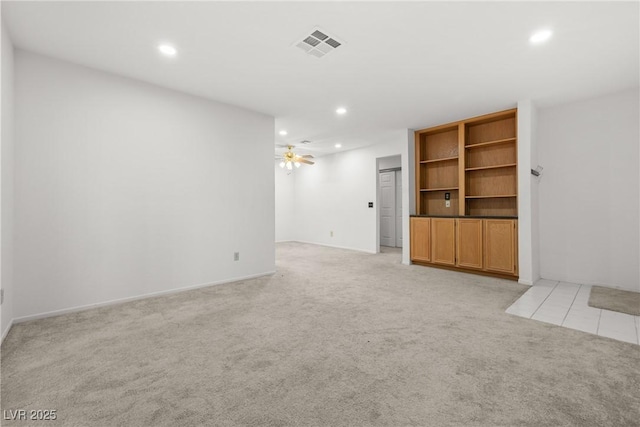 unfurnished living room featuring light colored carpet and recessed lighting