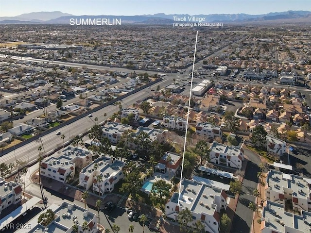 view of property location featuring mountains and nearby suburban area