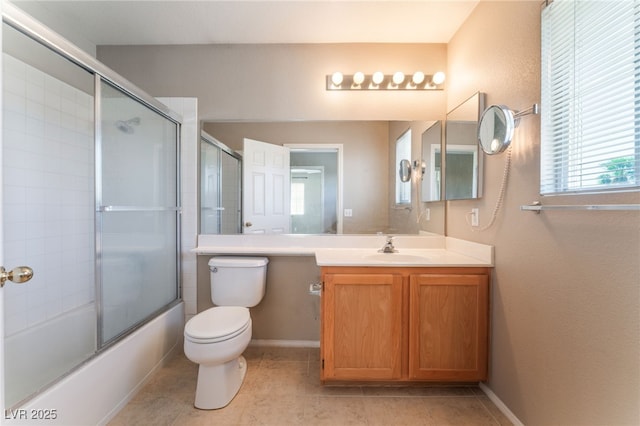 9360 Canalino Dr, Las Vegas, NV 89134 - bathroom featuring vanity, toilet, shower / bath combination with glass door, tile patterned floors, and baseboards