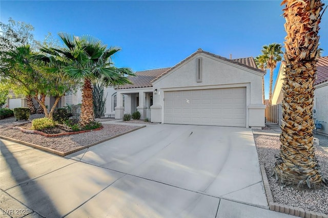 832 Seco Verde Ave, Henderson, NV 89015 - view of front of home featuring concrete driveway, a garage, stucco siding, a gate, and a tile roof